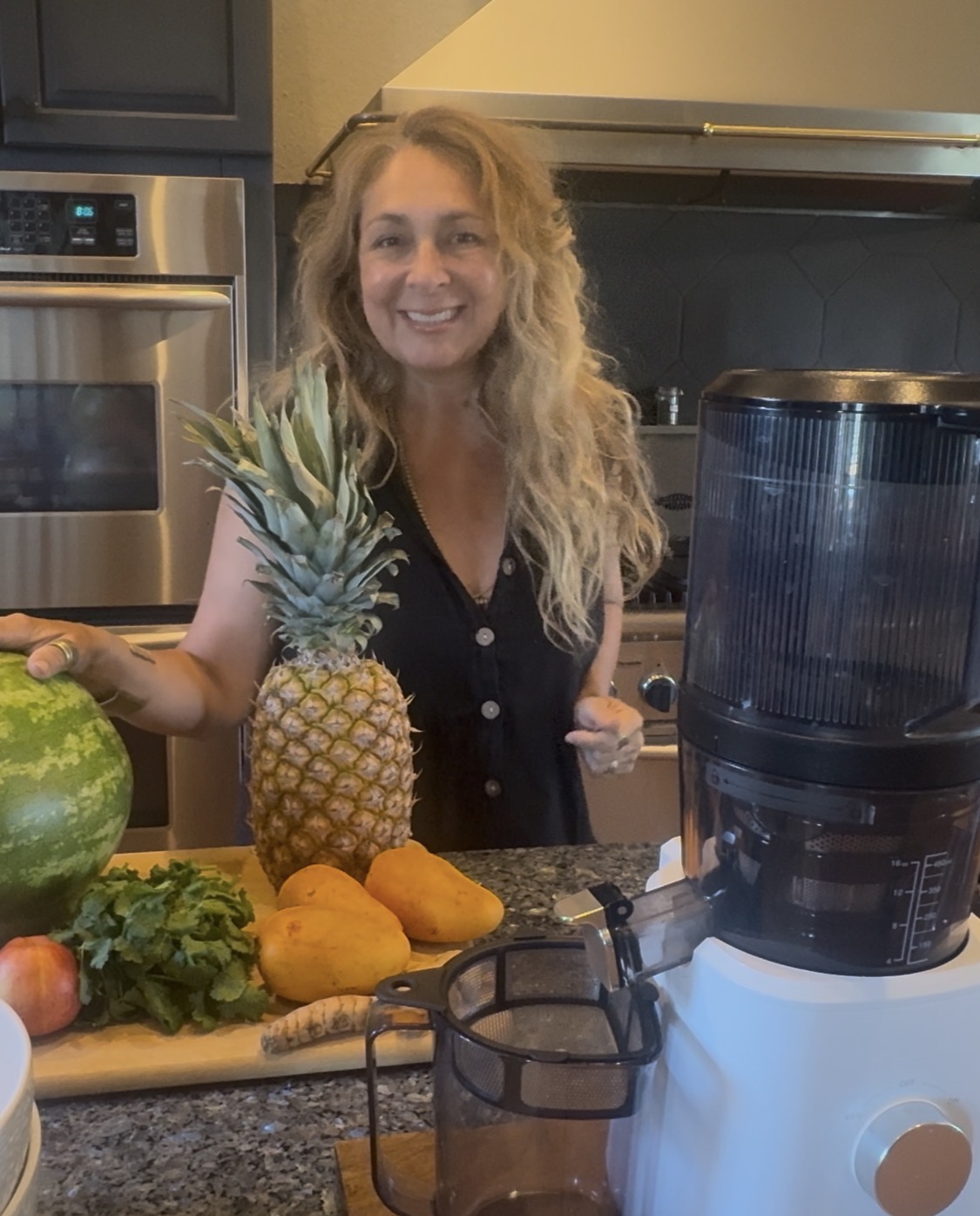 Alison juicing fresh pineapple, watermelon, and papaya in her Texas Hill Country kitchen