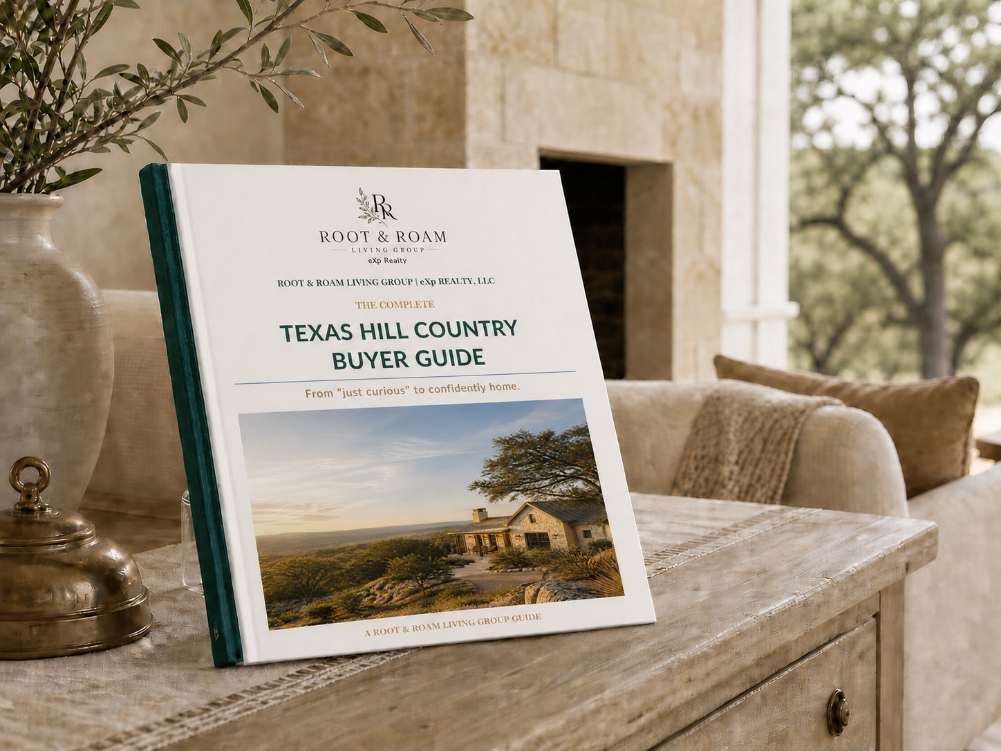 The Complete Texas Hill Country Buyer's Guide by Root & Roam Living - styled hardcover book on a rustic console table in a Hill Country living room