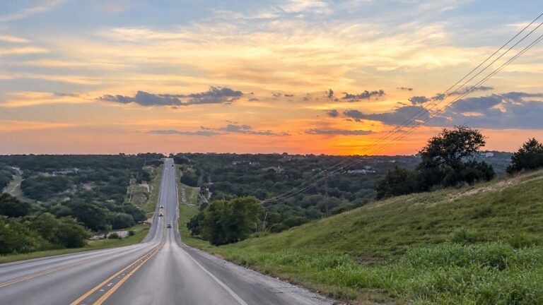 FM 306 winding through the Texas Hill Country at sunset near Canyon Lake