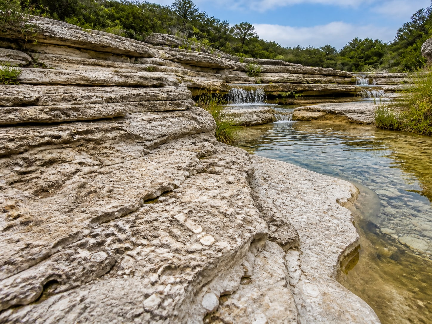 Illustrative limestone gorge with exposed rock layers and flowing water